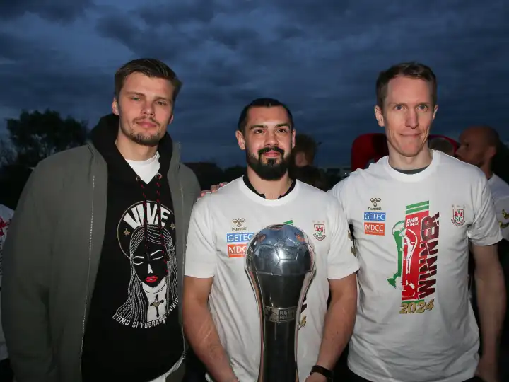 Goalkeepers Sergey Hernandez , Niclas Behrendt and Mikael Aggefors (all SC Magdeburg) with trophy at the reception of the current DHB Cup winner 2024 SC Magdeburg on 15.04.2024 at the GETEC Arena Magdeburg