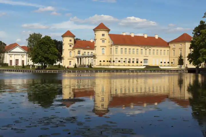 Reinsberg Castle is reflected in the lake in front of it.