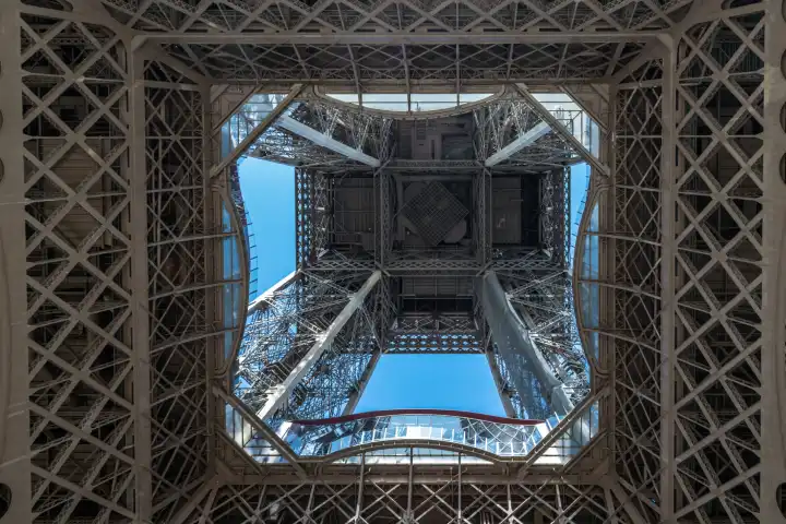 Paris Eiffel Tower from a frog s perspective with a view of the blue sky