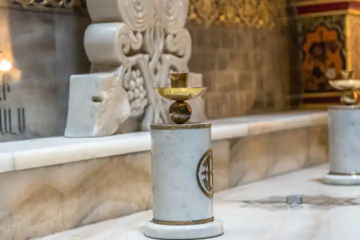 White marble candlestick on an altar in the Church of the Holy Sepulchre in Jerusalem, Israel. Detail inside the Church of the Holy Sepulchre.
