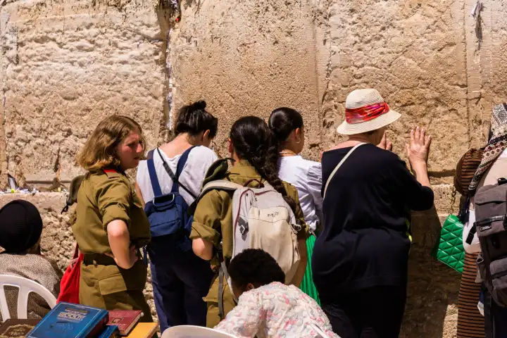 Praying women and soldiers of the Israeli army at the Wailing Wall in Jerusalem, Israel.