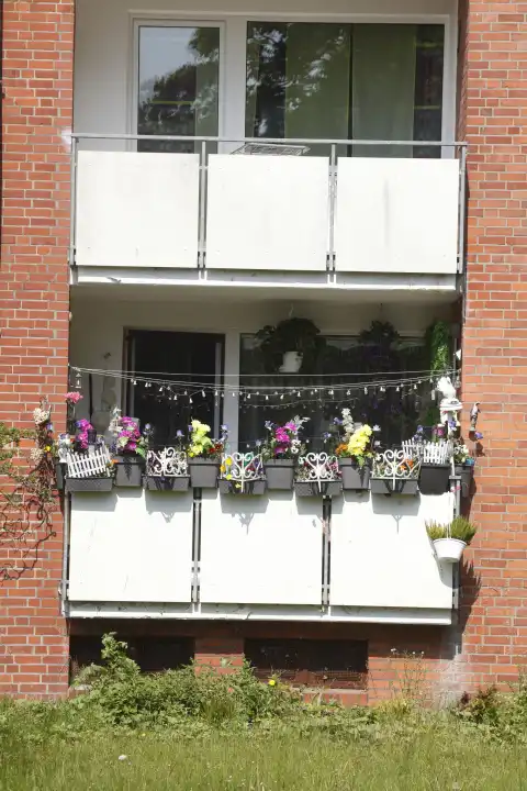 Balconies and flower boxes on a ModernBrick residential building, apartment building, Bremen, Germany