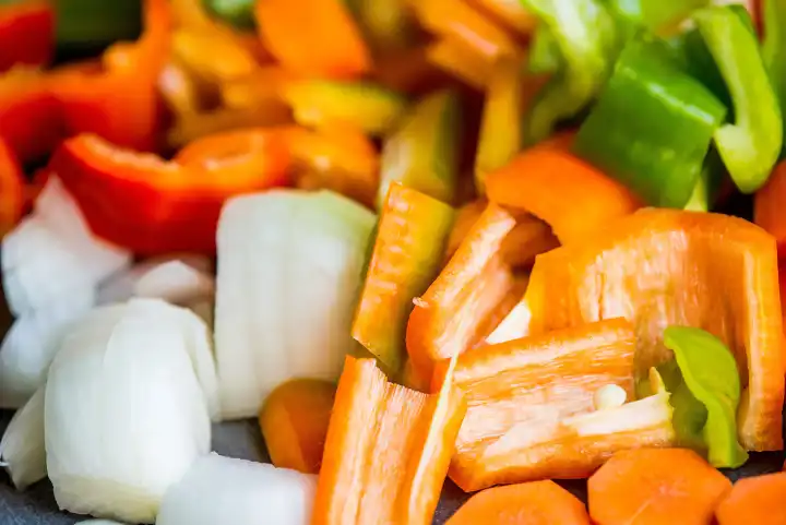 sliced carrots, peppers and onions in a closeup