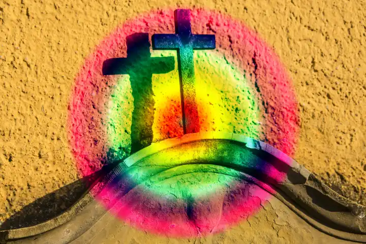 Christian cross on a tombstone in a LGBTQ color circle