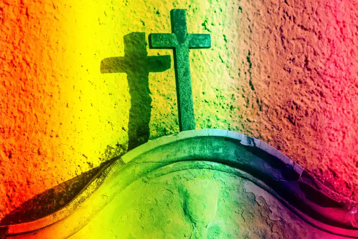 Christian cross on a tombstone in LGBTQ colors