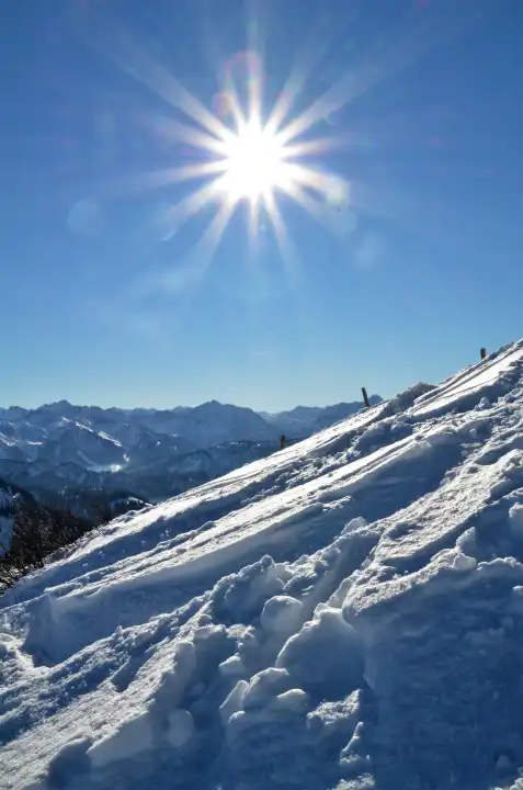 Bright sunshine on a snowshou hike in the alps, Germany