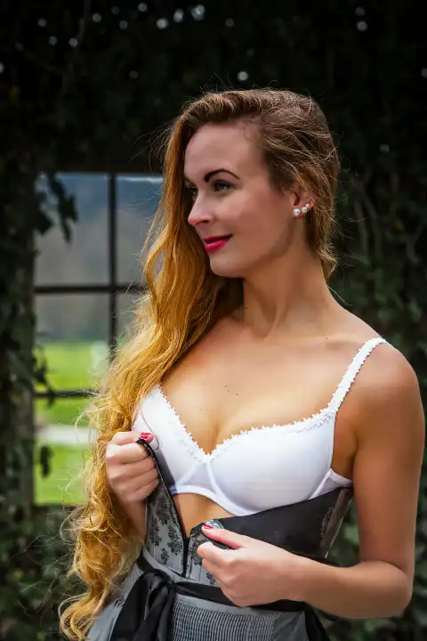 Young woman with stunning cleavage in perfect dirndl bra