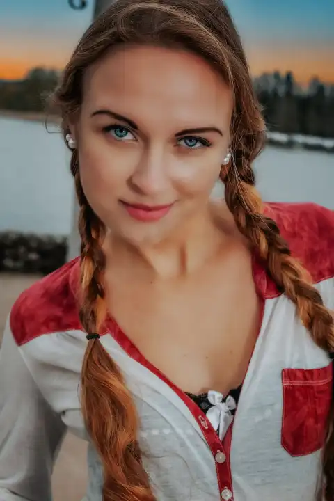 Close up face and chest area of young woman looking directly into camera