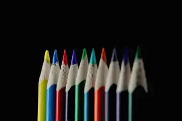 Colored pencils against a black background