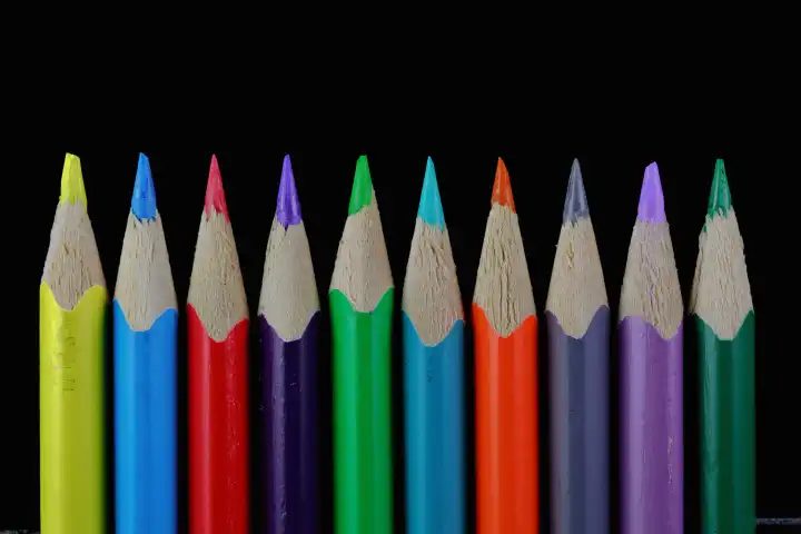Colored pencils against a black background