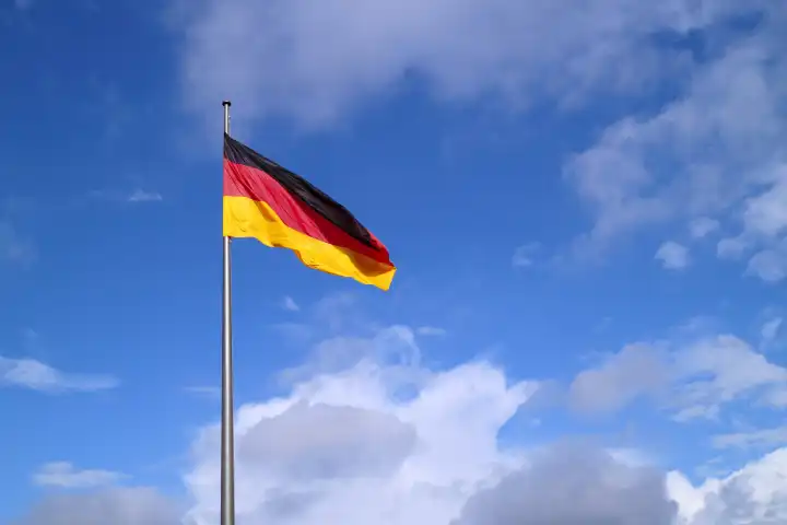 German flag in front of a blue sky