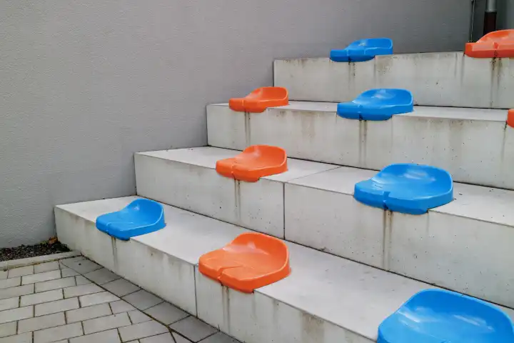 Colored seats on concrete stairs