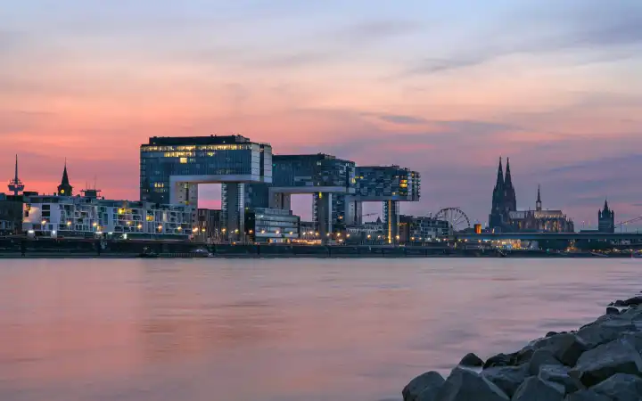 COLOGNE, GERMANY - JUNE 23, 2023: Panoramic image of modern buildings in the harbor of Cologne during sunset on June 23, 2023 in Germany, Europe