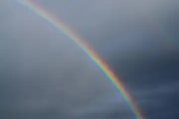 Low angle view to sky with rainbow