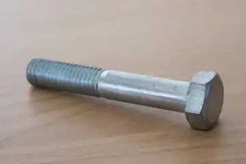 Hexagon head screw with shank on wooden background, steel screw, machine screw, wrench screw