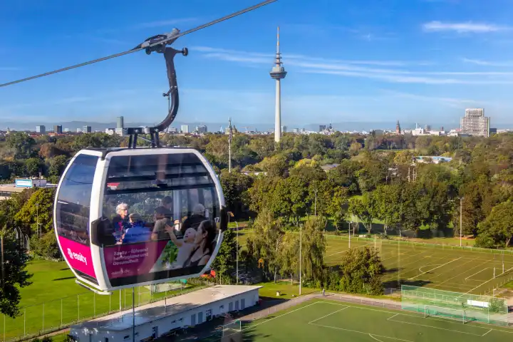 BUGA (Federal Horticultural Show) Mannheim 2023: Ride the cable car towards Luisenpark. The cable car connects the two exhibition grounds Luisenpark and Spinelli Park. In the background you can see the well-known telecommunications tower, one of Mannheim's landmarks.