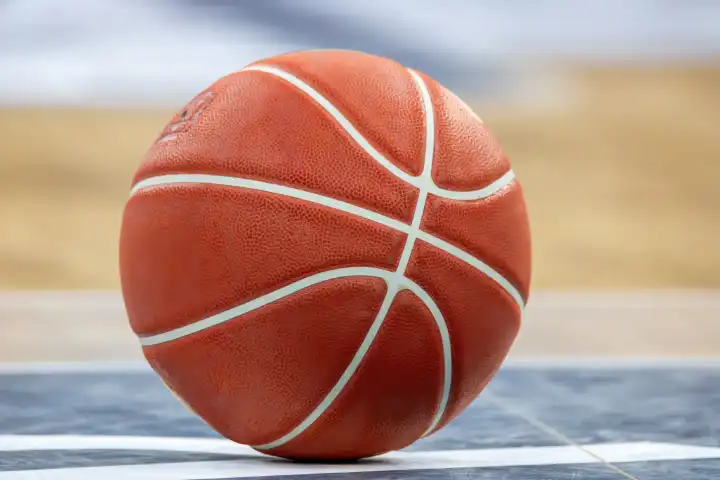Close-up of basketball on the floor of a hall