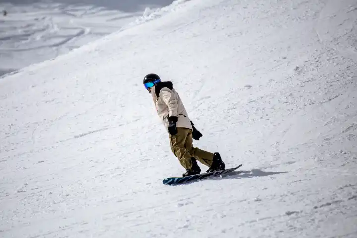 March 26, 2024, Grindelwald (Switzerland): Close-up of a snowboarder on the piste