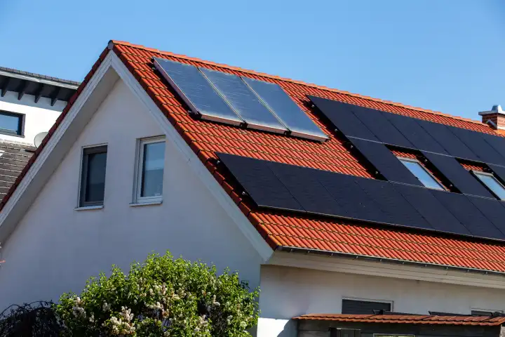 Detached house with photovoltaic system and solar thermal collectors