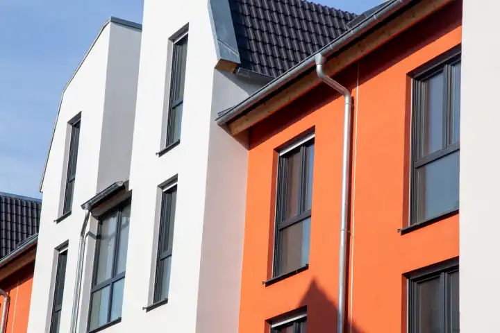 Apartment building with a beautiful white and Mediterranean orange façade