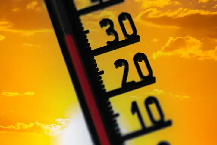 Symbolic image of heat: Thermometer in front of a summer sky (Composing)