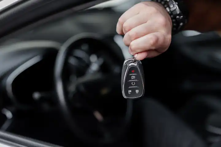 Man's hand holds the car keys. Buying and selling cars. Test Drive