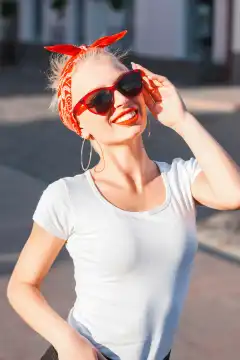 Portrait of a stylish young hipster girl with sunglasses in the city.