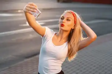 Hübsches Hipster-Mädchen, das ein Selfie macht und ein Entengesicht. Sendet Küsse. Instagram