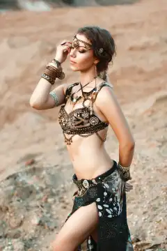Fashion Beauty and stylish girls. Spirituality dance. Beautiful Sexy Woman With Luxury glossy gold eastern Makeup danceing tribal fusion. Indian accessories (oriental jewelry)