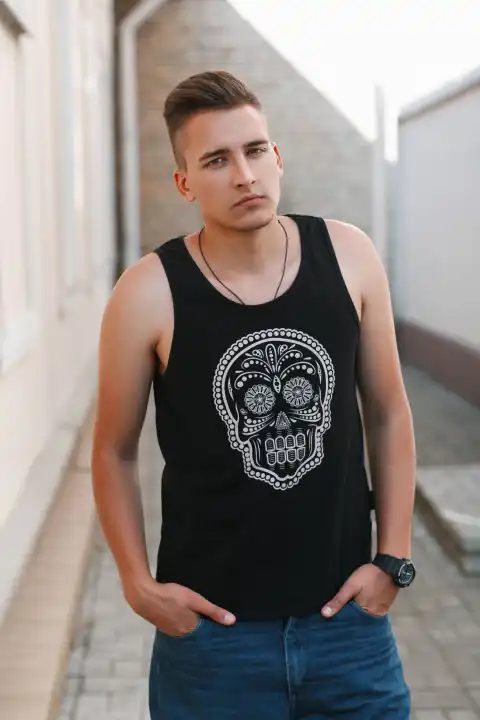 Portrait of young stylish man in a black shirt with a skull.