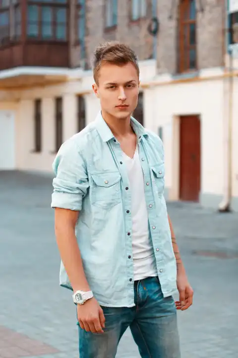 Hübscher junger Mann in Jeanskleidung in der Stadt.