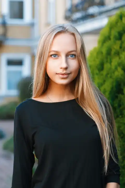 Beautiful blue-eyed girl on the background of houses
