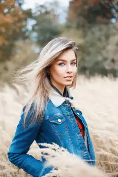 Stylish beautiful young woman in jeans jacket with fur.