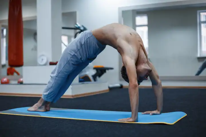 Man at yoga class in fitness studio