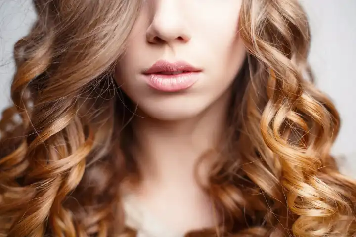 Beautiful pink lips close-up. Girl with curly hair