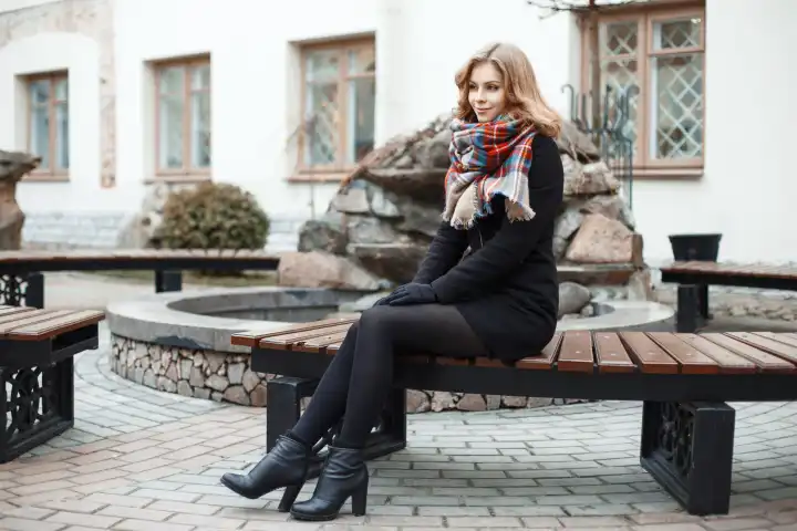 Stylish young woman relaxing on a bench