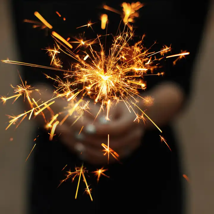 Amazing sparklers in female hands.