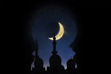 Mosque at night with a month. Silhouette on the background of the starry sky. Ramadan.