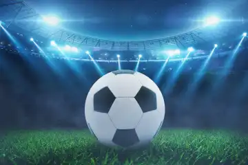 Soccer ball on the grass in a modern stadium with blue bright floodlights. Soccer World Cup. Euro 2024, creative idea. Champions League game at night. Winner
