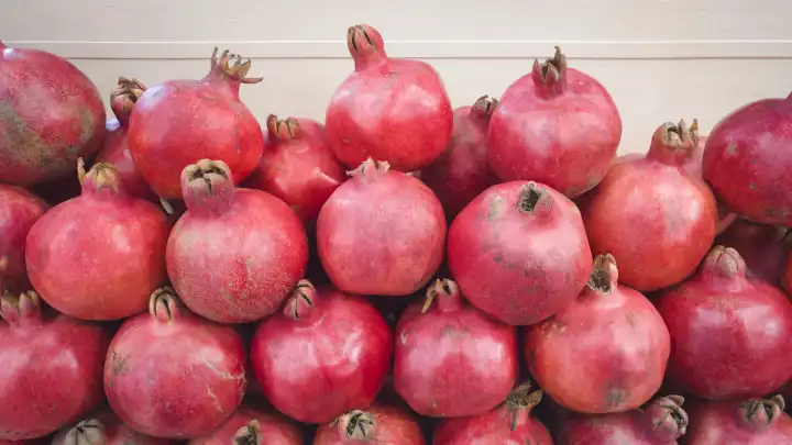 Heap of pomegranate fruits on the showcase of market