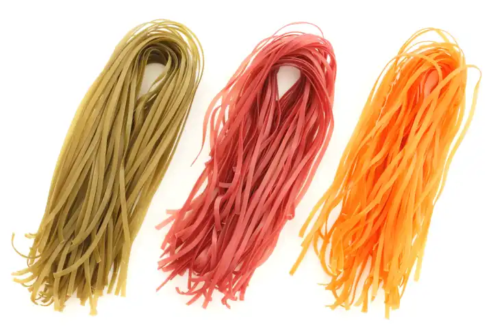 The set of three different natural vegetable colored pasta uncooked.