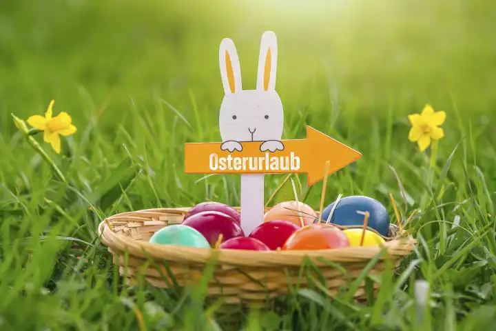30 March 2023: Easter nest with Easter bunny and arrow with inscription: Easter vacation. Easter vacation concept PHOTOMONTAGE