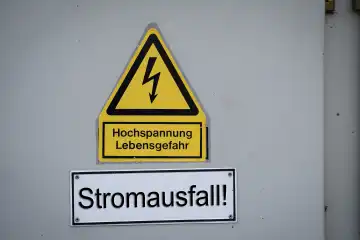 Augsburg, Bavaria, Germany - 27 April 2023: Sign Achtung Hochspannung with the inscription: Power failure. Blackout and power failure concept PHOTOMONTAGE
