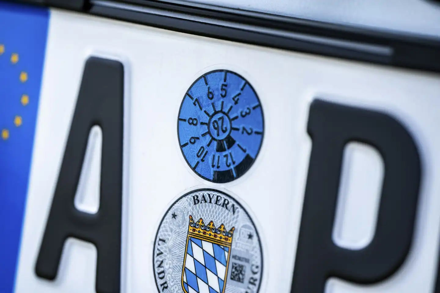 Bavaria, Germany - 2 June 2023: Blue TÜV sticker valid until the