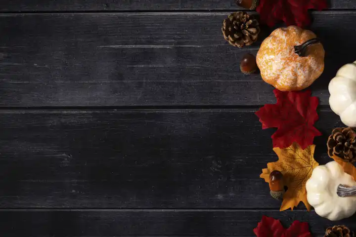 19 August 2023: Autumn background text free space pumpkin acorn and leaves on wooden table