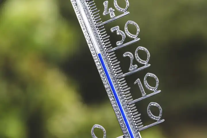 Bavaria, Germany - 25 August 2023: Thermometer in the sun at 30 degrees Celsius. Summer, sun and heat concept