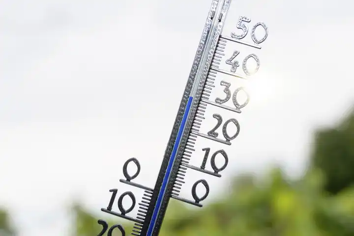Bavaria, Germany - 25 August 2023: Thermometer in the sun at 30 degrees Celsius. Summer, sun and heat concept