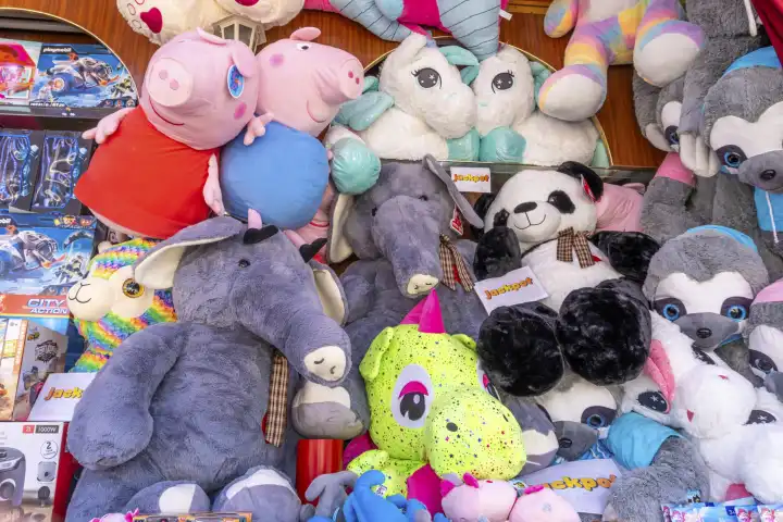 Bad Saulgau, Baden-Württemberg, Germany - 15 July 2023: Plush figures and stuffed animals with signs "Jackpot" at a lottery ticket booth at a fair or folk festival