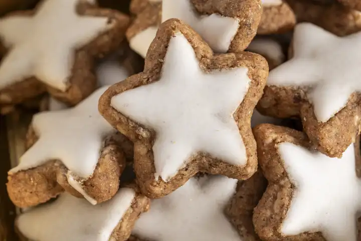 Bavaria, Germany - 29 August 2023: Close up of cinnamon star cookies at Christmas. Cinnamon stars with white icing