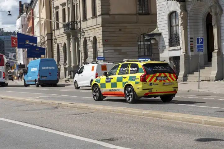 Stockholm, Sweden - 21 July 2023: An emergency medical vehicle with blue lights on the way to a mission in Stockholm, Sweden
